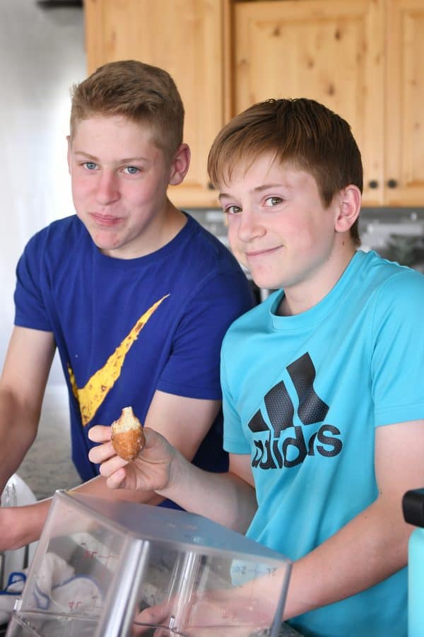 Two teenage boys testing the best homemade glazed donuts recipe.