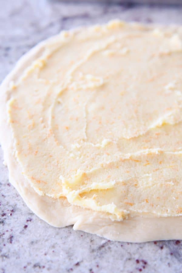 orange filling spread on sweet dough for homemade orange sweet rolls