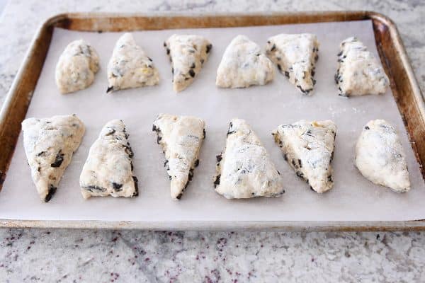 Scone triangles on parchment lined baking sheet.
