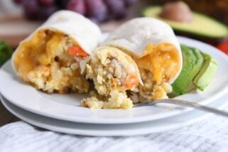 easy freezer breakfast burrito cut in half with bite on fork on white plate