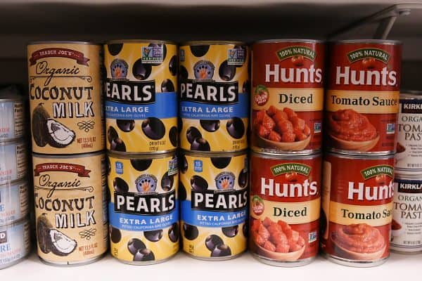 olives and coconut milk and diced tomatoes on pantry shelf