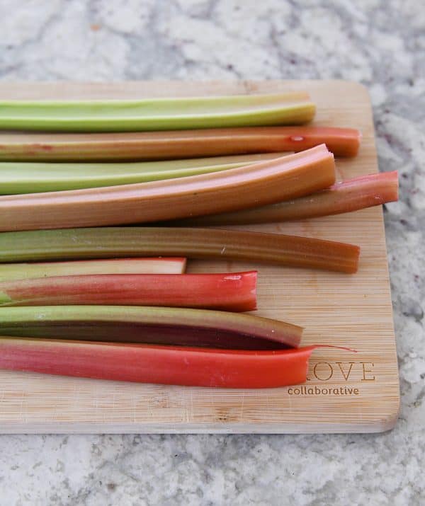 stalks of rhubarb on wood cutting board