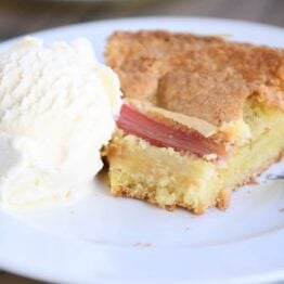 half a piece of cake on white plate with ice cream