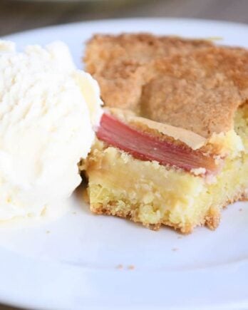 half a piece of cake on white plate with ice cream