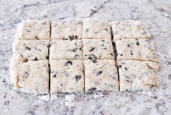 Cutting chocolate chunk biscuits into squares.