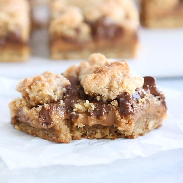 bite taken out of caramel peanut butter caramel bar