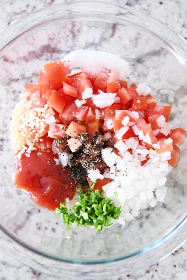 ketchup, jalapenos, onions, tomatoes and garlic in glass bowl