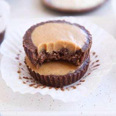two unwrapped no-bake peanut butter cups stacked with bite taken out of top pb cup