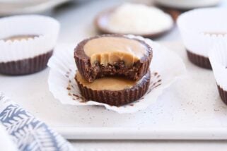 two unwrapped no-bake peanut butter cups stacked with bite taken out of top pb cup