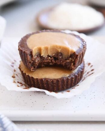 two unwrapped no-bake peanut butter cups stacked with bite taken out of top pb cup