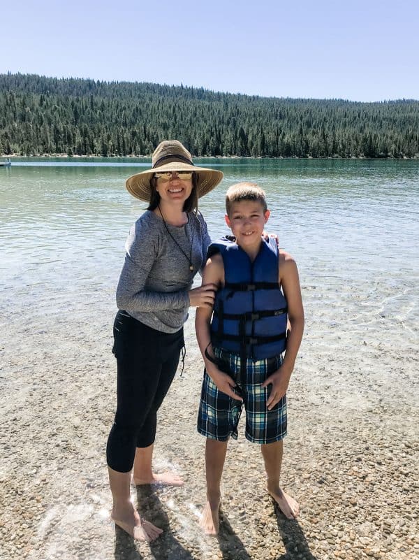 mom and son standing in water at redfish lake