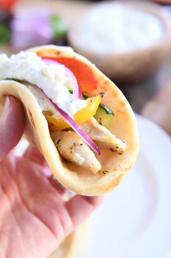 Holding chicken tzatziki wrap.