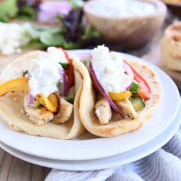 two sheet pan chicken tzatziki wraps on white plate