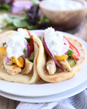 two sheet pan chicken tzatziki wraps on white plate