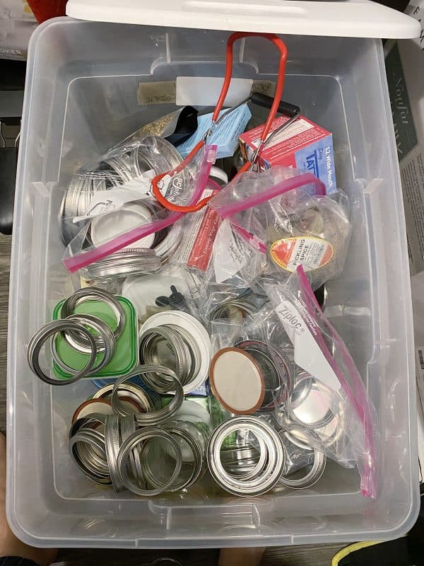 plastic bin of canning lids and bands