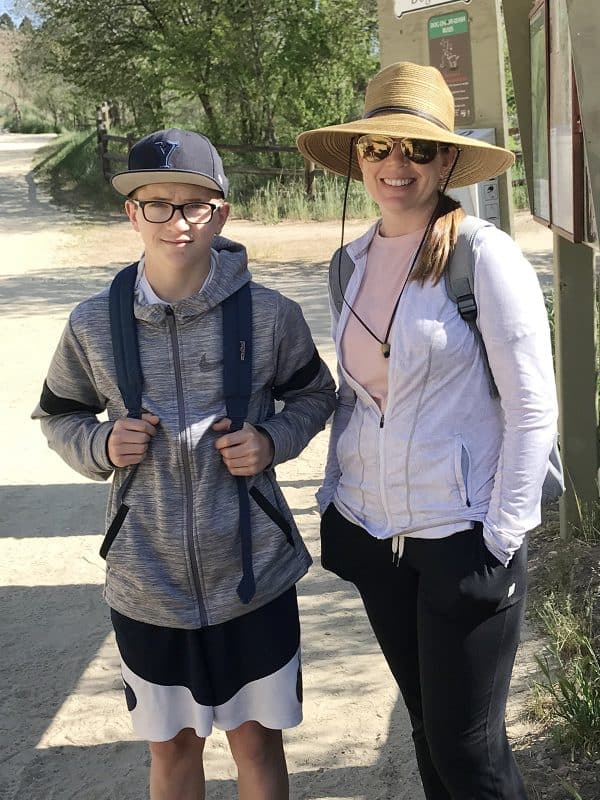 mom and son hiking on dirt path