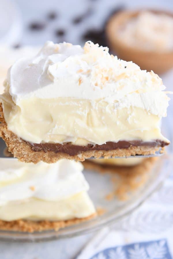 Piece of banana coconut cream pie on pie server.