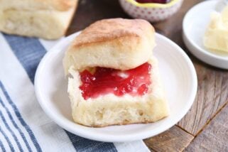 fluffy dinner roll cut in half and spread with butter and jam