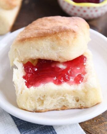 fluffy dinner roll cut in half and spread with butter and jam