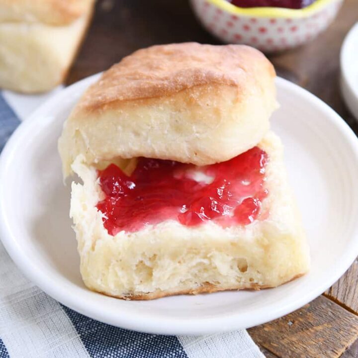 fluffy dinner roll cut in half and spread with butter and jam