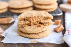 two brown butter caramel snickerdoodles stacked with one cookie broken in half on top