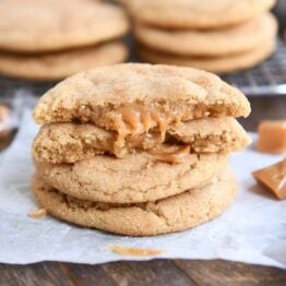 two brown butter caramel snickerdoodles stacked with one cookie broken in half on top