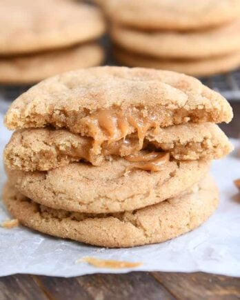 two brown butter caramel snickerdoodles stacked with one cookie broken in half on top