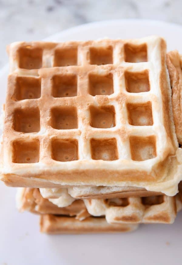 stack of sourdough waffles on white plate