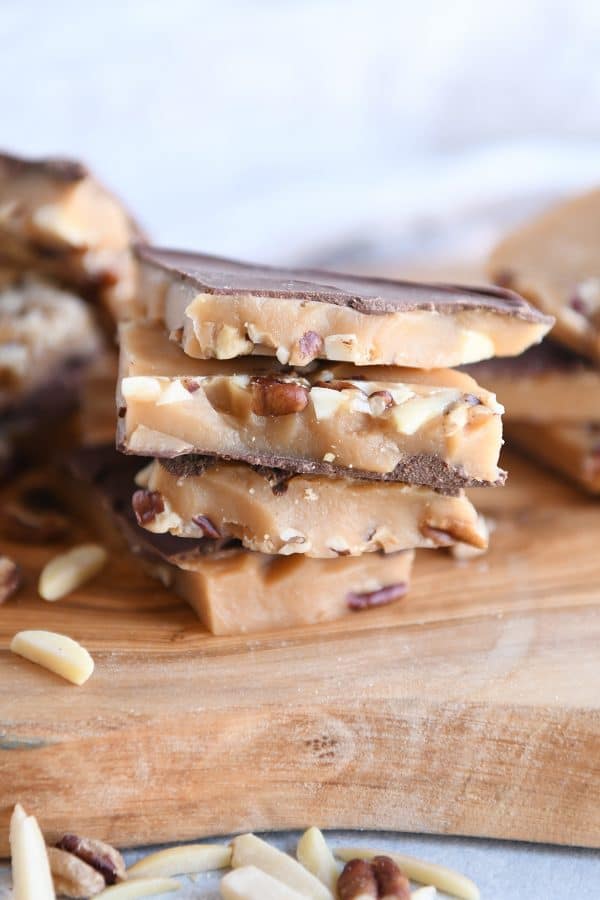 Homemade toffee cooling on parchment lined sheet pan.