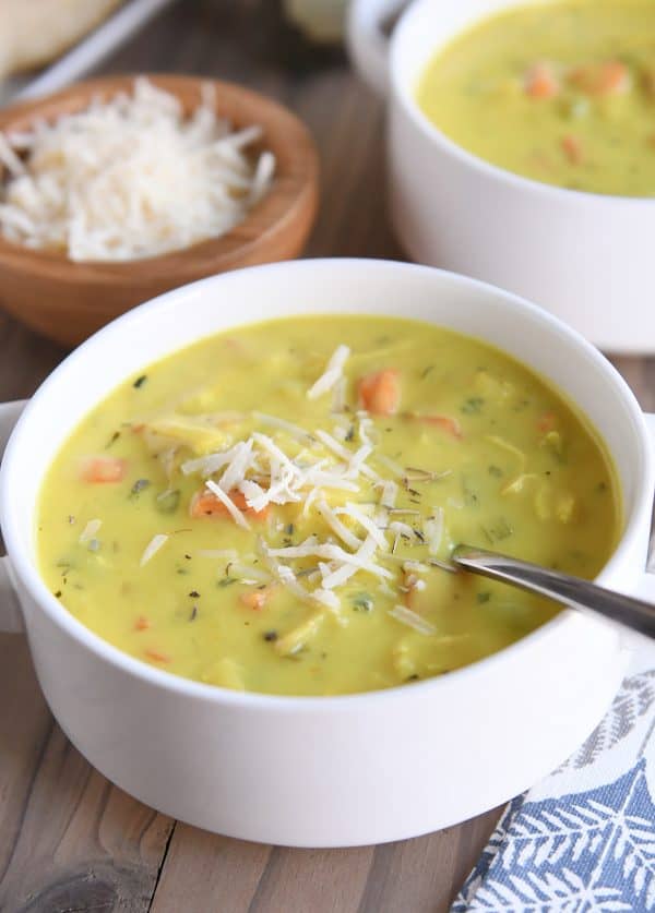 creamy chicken soup in white bowl with parmesan sprinkled on top