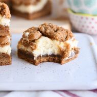 gingerbread cookie cheesecake bar with bite taken out on white tray