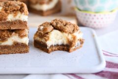 gingerbread cookie cheesecake bar with bite taken out on white tray