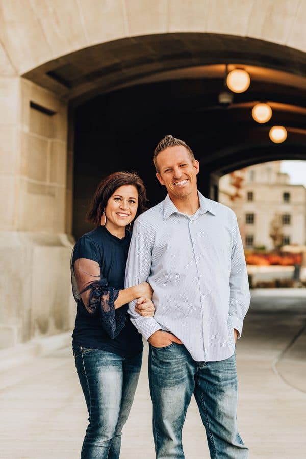 man and woman standing in front of tunnel