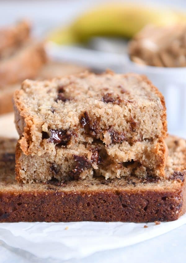 Three slices of peanut butter banana bread on white napkin.