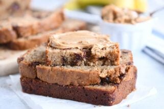 three peanut butter banana bread slices with peanut butter spread on top