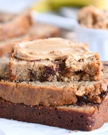 three peanut butter banana bread slices with peanut butter spread on top