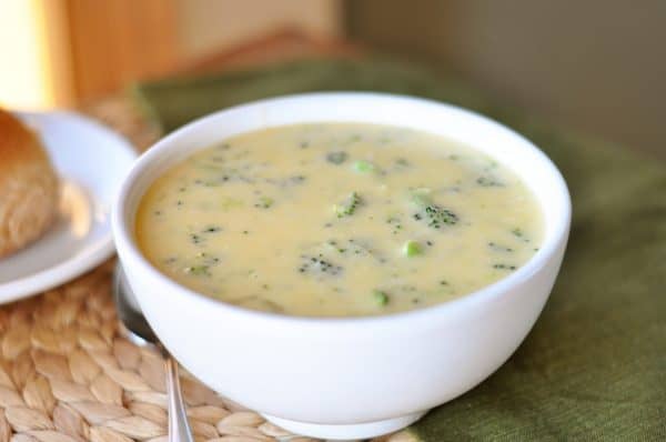 White bowl of broccoli cheese soup.
