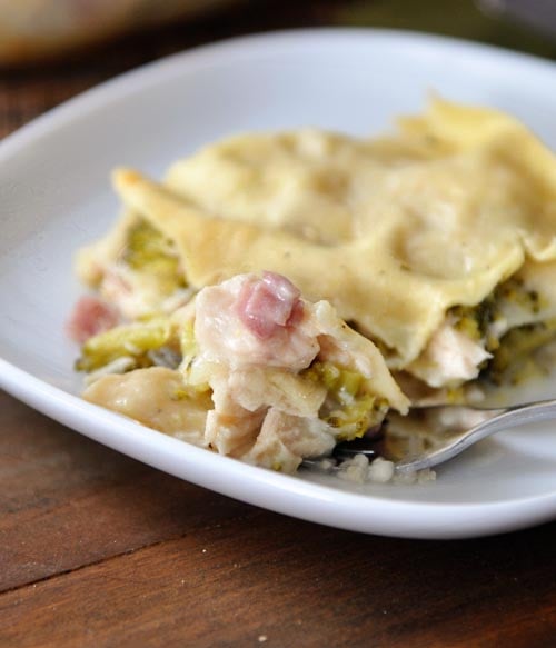 A piece of chicken cordon bleu lasagna on a white plate.