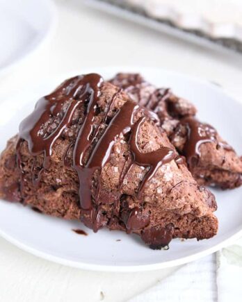 two triple chocolate scones on white plate