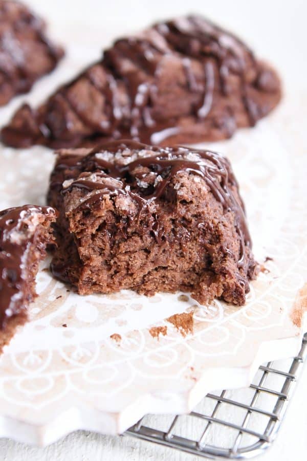 Half of triple chocolate scone on white platter.