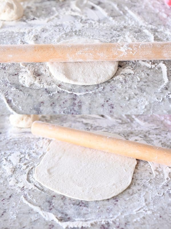 Rolling out flatbread on floured counter with wood rolling pin.