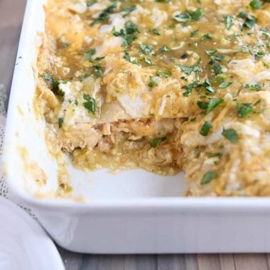 piece removed from pan of chicken enchilada casserole