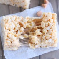 butterscotch rice krispie pulled in half on white parchment paper