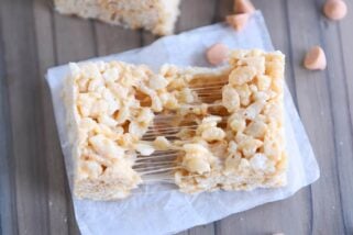 butterscotch rice krispie pulled in half on white parchment paper