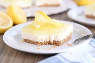 square of lemon white chocolate cream bar on white plate with bite taken out