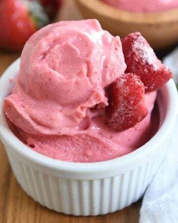 homemade strawberry frozen yogurt in white cup with silver spoon