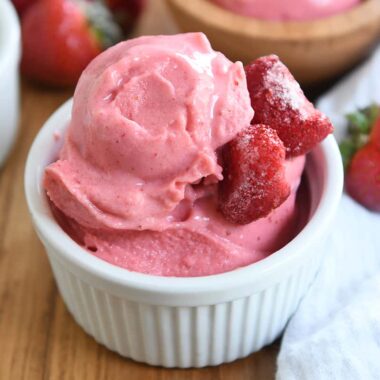 homemade strawberry frozen yogurt in white cup with silver spoon