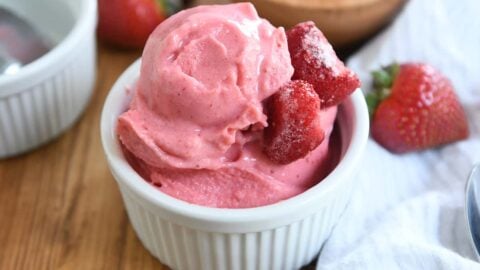 homemade strawberry frozen yogurt in white cup with silver spoon