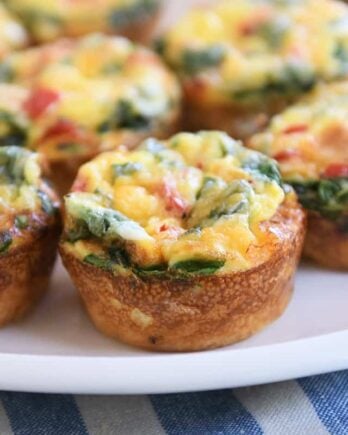 five hash brown veggie egg cups on white platter