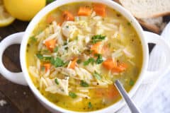 white bowl with handles filled with lemon chicken orzo soup